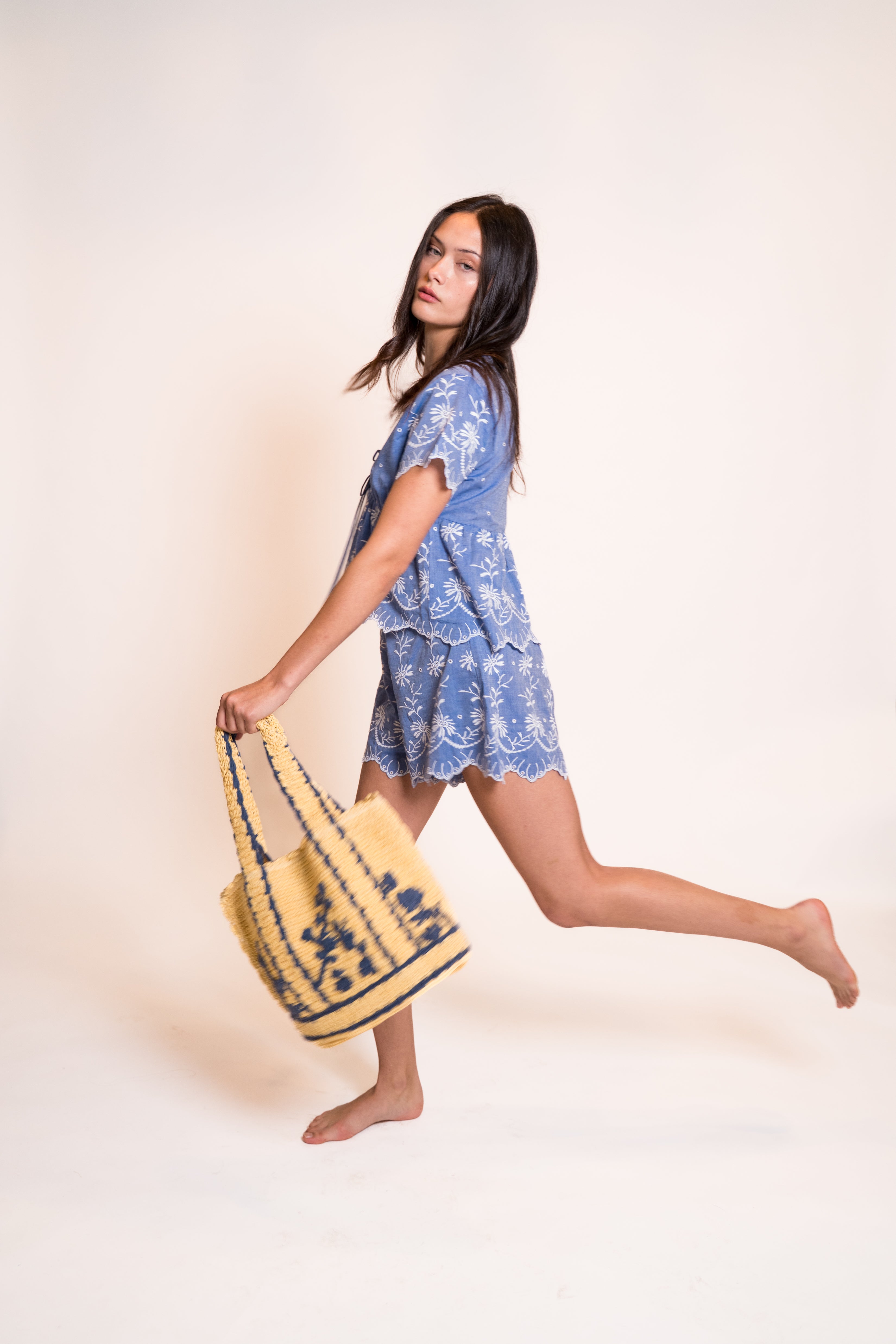 Z&L Europe Serena Shorts in blue embroidered cotton worn with the matching top and a straw bag