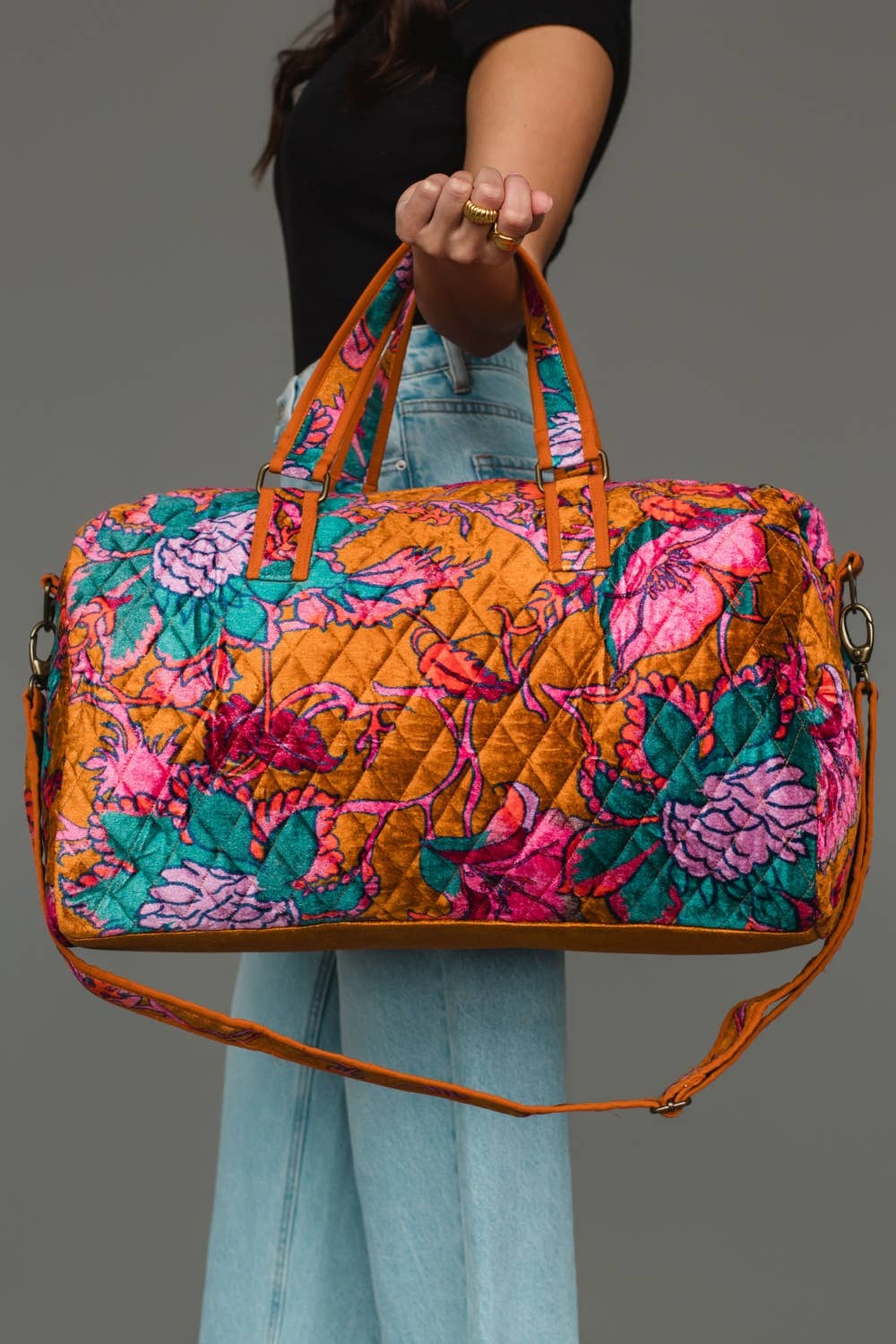 Wildflower Woven Duffel in burnt orange floral, carried