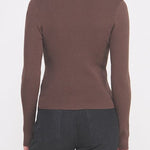 Woman wearing a brown long-sleeve top on a white background