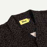 Black patterned shirt with a yellow label on a light gray background