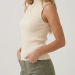 Cream sleeveless turtleneck knit top, side view
