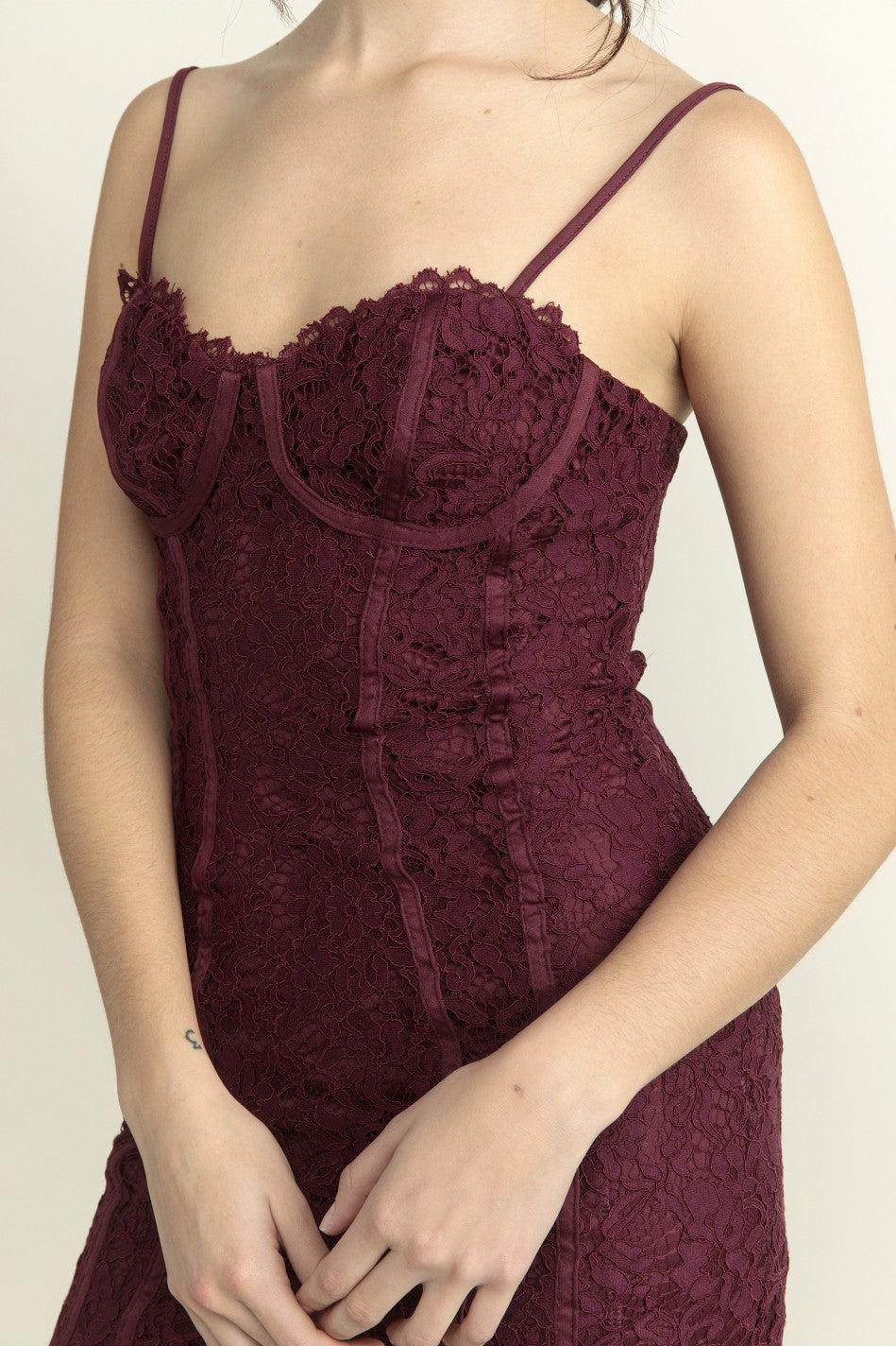 Maroon lace dress on a plain background