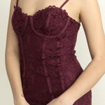 Maroon lace dress on a plain background