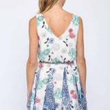 Woman wearing a floral dress with a white background