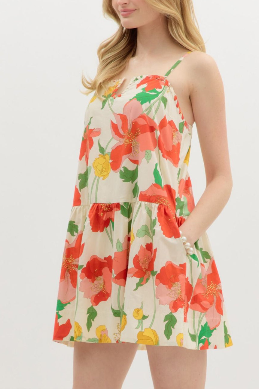 Woman wearing a floral dress with red flowers on a white background