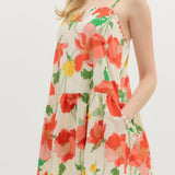 Woman wearing a floral dress with red flowers on a white background