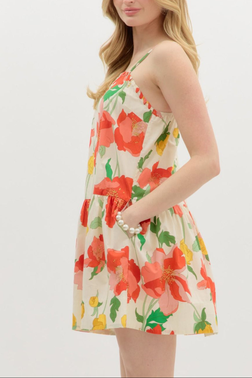 Woman wearing a floral dress with red flowers on a white background