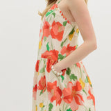 Woman wearing a floral dress with red flowers on a white background