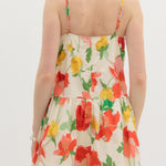 Woman wearing a floral dress with a white background