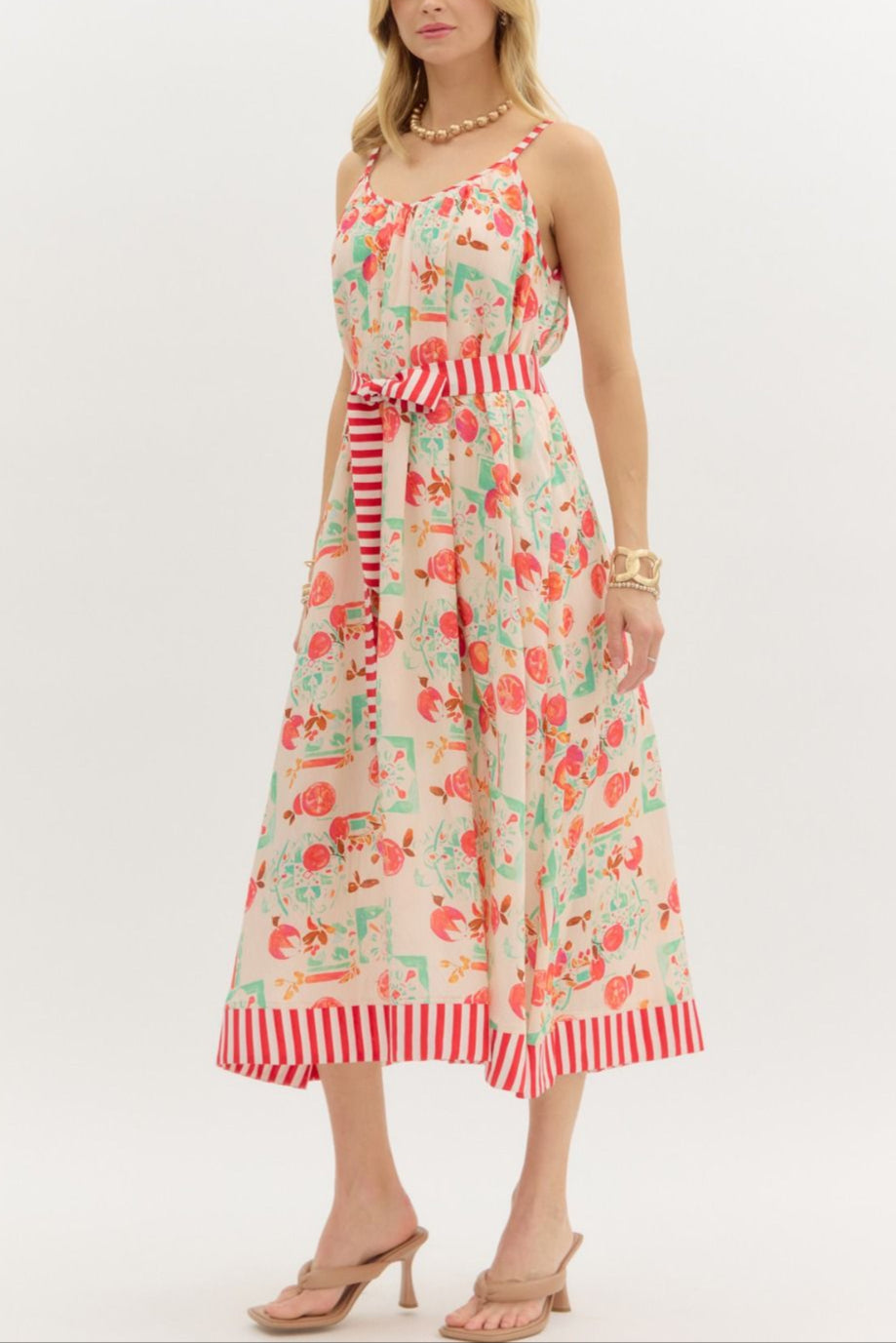 Woman wearing a floral dress with red stripes on a white background