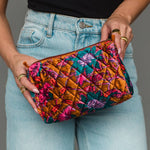 Wildflower Woven Travel Pouch in burnt orange floral, held