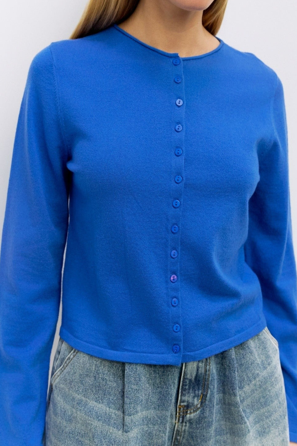 Cambria Rolled Neck Cardigan in blue, detail of rolled neckline and button front