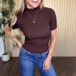 Clove Scallop Mock Neck Sweater in Brown styled on model