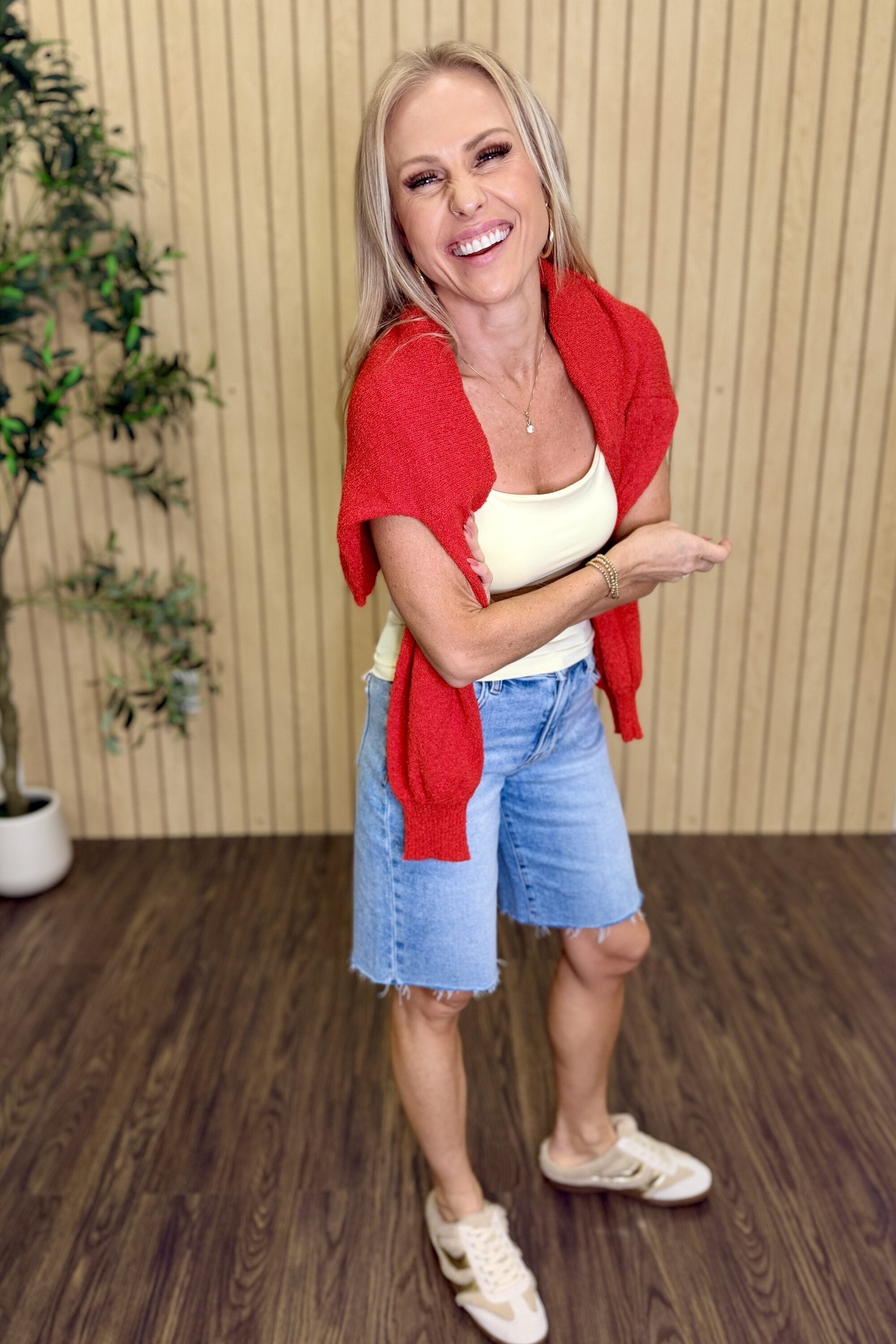 Melanie Clean Line Square Cami in Pale Banana with a red sweater over the shoulders